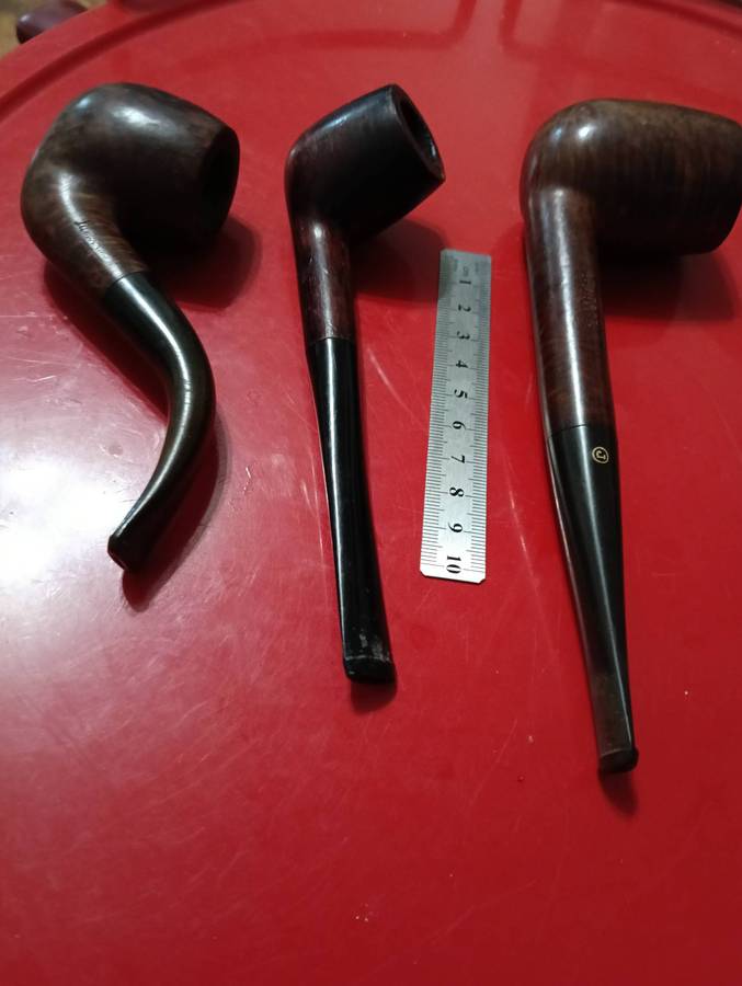 THREE SMOKING PIPES.