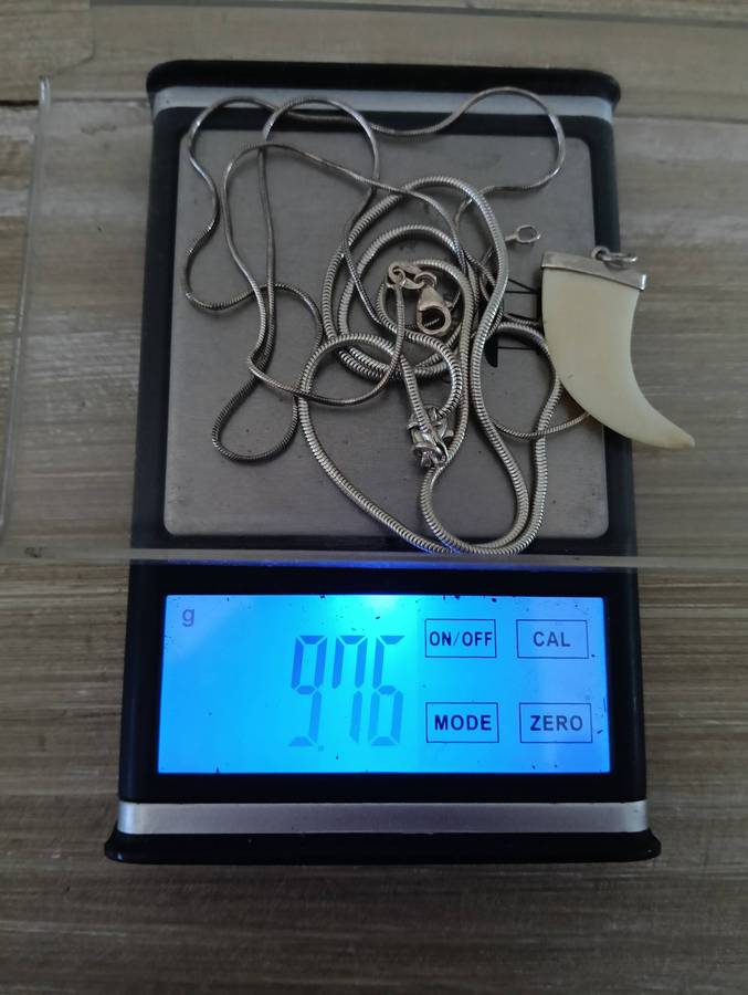 SILVER NECKLACES, WITH CLAW PENDANT.