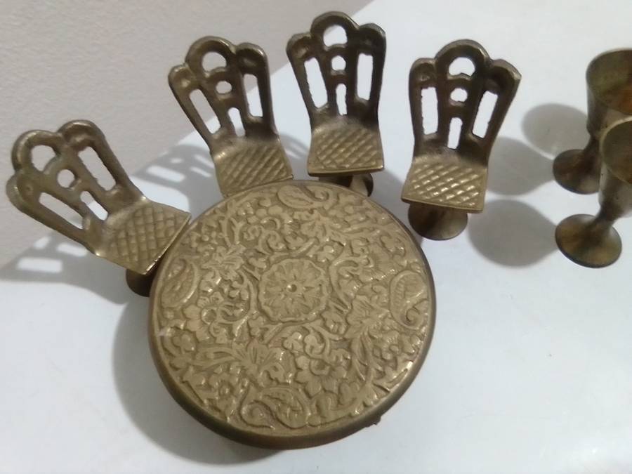 Handcrafted miniature bras dining table set that includes a table and four chairs and 4 goblets.