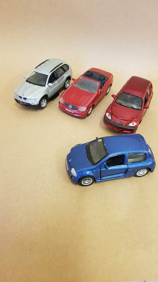 4 Scale model Maisto cars. Renault Clio , Chrysler PT Cruiser ,Mercedes SLK and BMW X5.