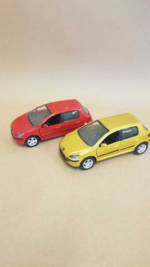 Two Peugeot 307 scale model cars. Dated 2002.