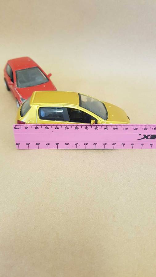 Two Peugeot 307 scale model cars. Dated 2002.