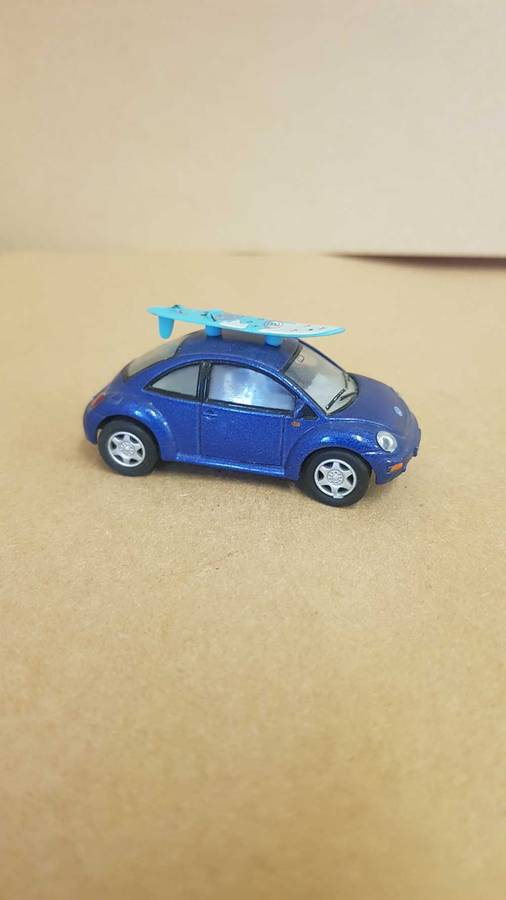 1:64 scale VW Beetle . By Kinsmart. With surfboard on roof.
