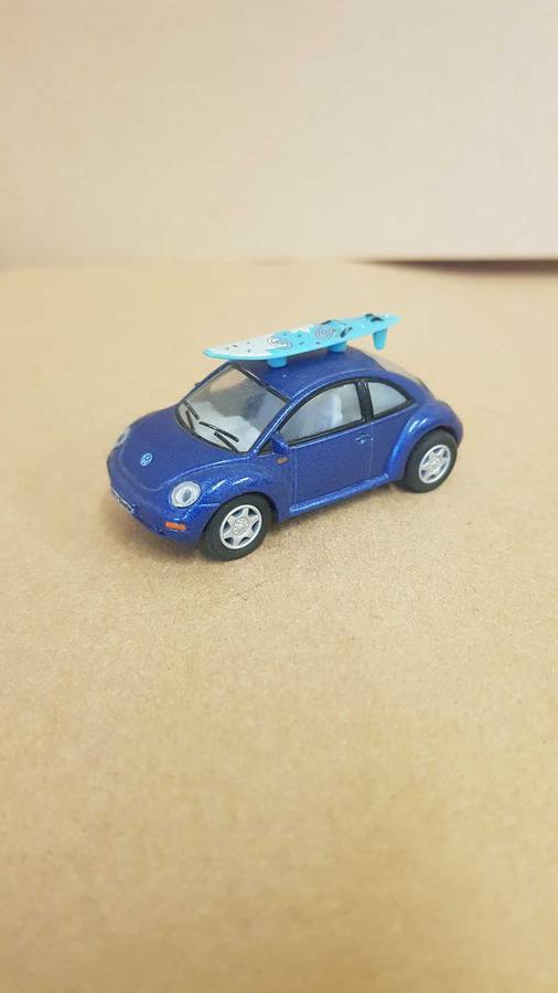 1:64 scale VW Beetle . By Kinsmart. With surfboard on roof.