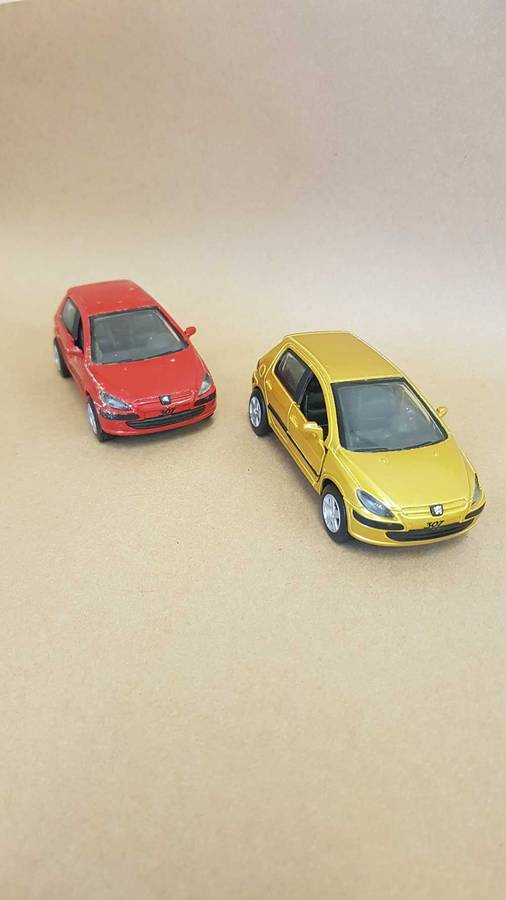 Two Peugeot 307 scale model cars. Dated 2002.