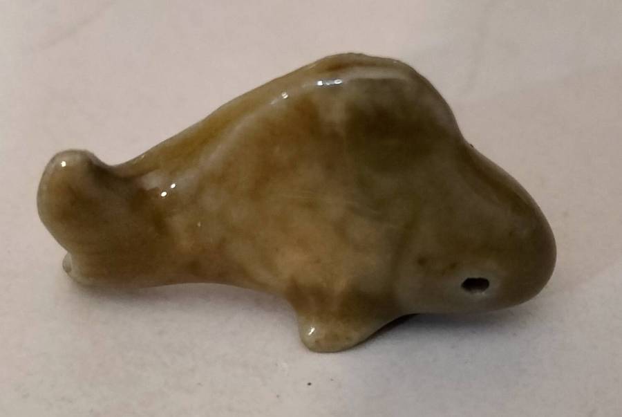 An Extremely Small and Delicate Glazed Ceramic Dolphin.