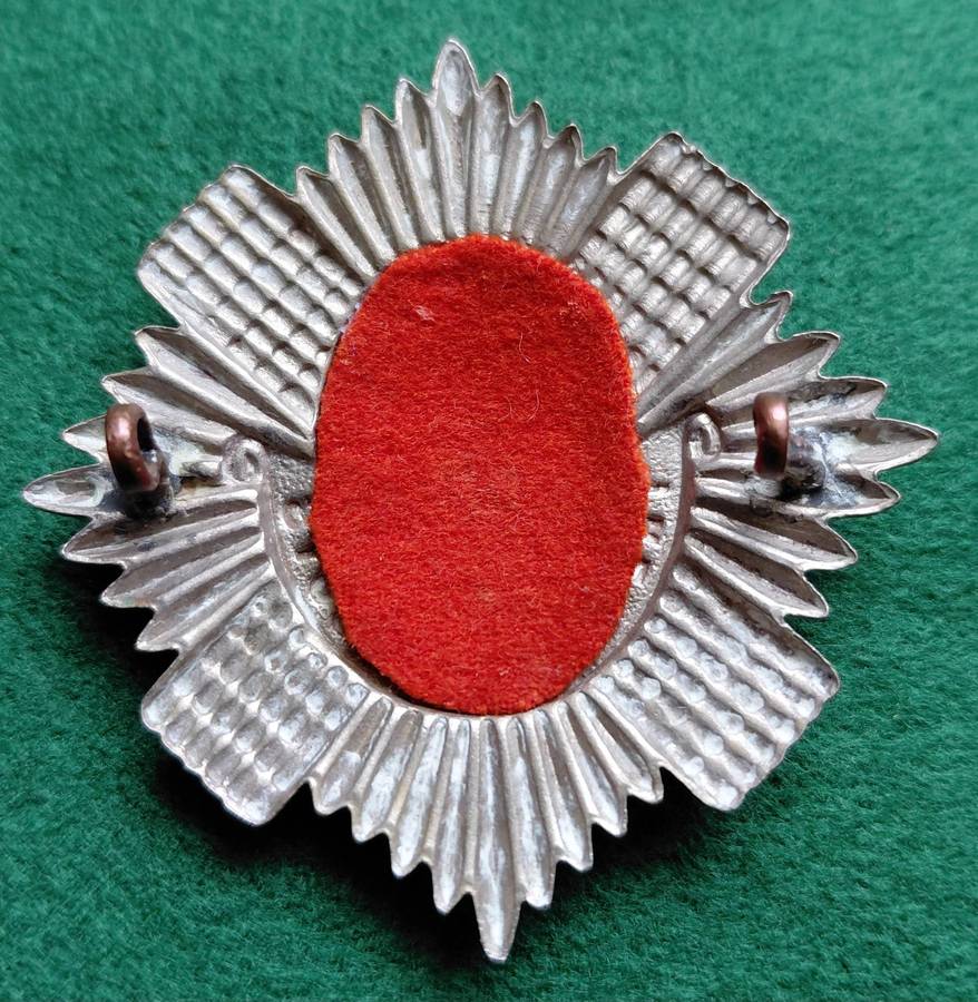 British Army, Royal Scots BiM cap badge with red backing for 1st Battalion