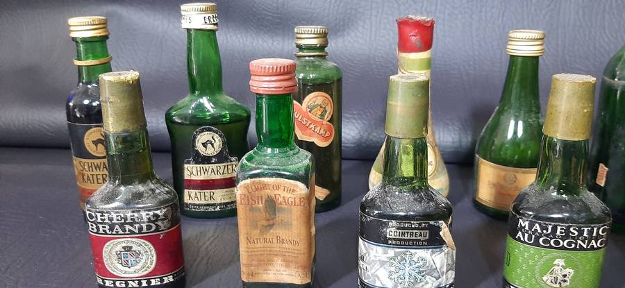 GREEN GLASS MINIATURE LIQUOR BOTTLES  VINTAGE BAR DISPLAY LOT OF 12