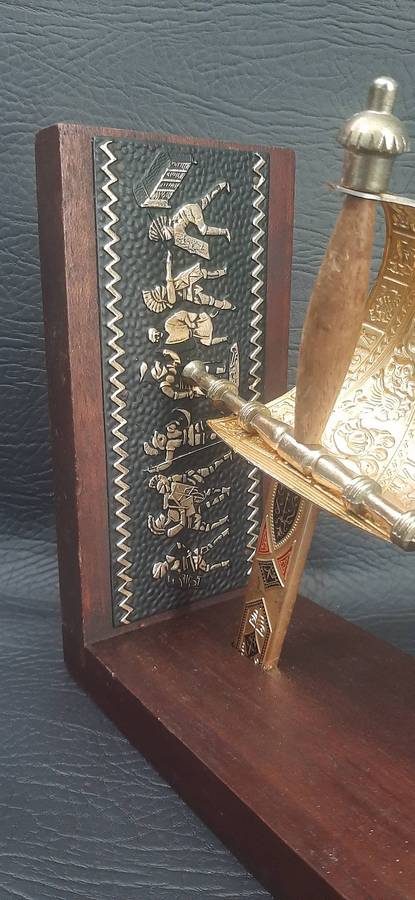 SINGLE VINTAGE BOOKEND WITH SUSPENDED SWORD HILT  SCULPTURAL FUNCTIONALITY WITH MARTIAL ELEGANCE