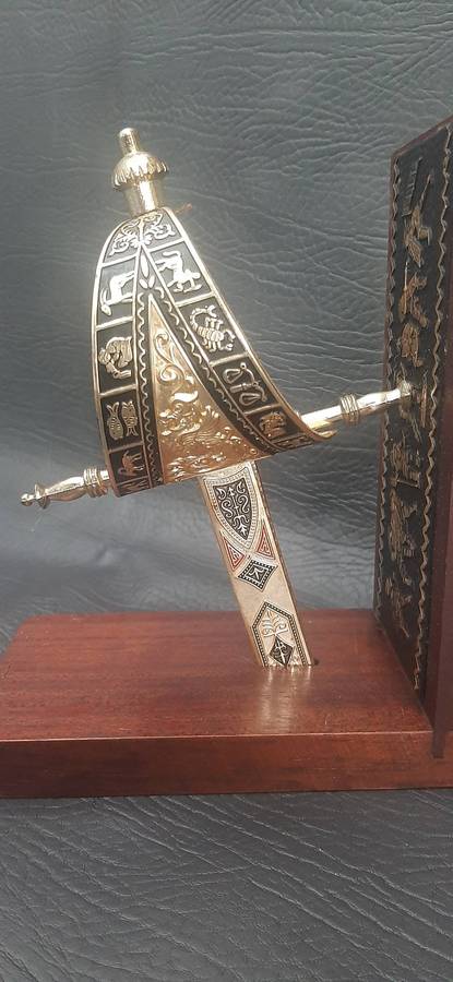 SINGLE VINTAGE BOOKEND WITH SUSPENDED SWORD HILT  SCULPTURAL FUNCTIONALITY WITH MARTIAL ELEGANCE