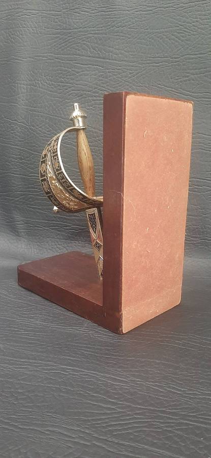 SINGLE VINTAGE BOOKEND WITH SUSPENDED SWORD HILT  SCULPTURAL FUNCTIONALITY WITH MARTIAL ELEGANCE
