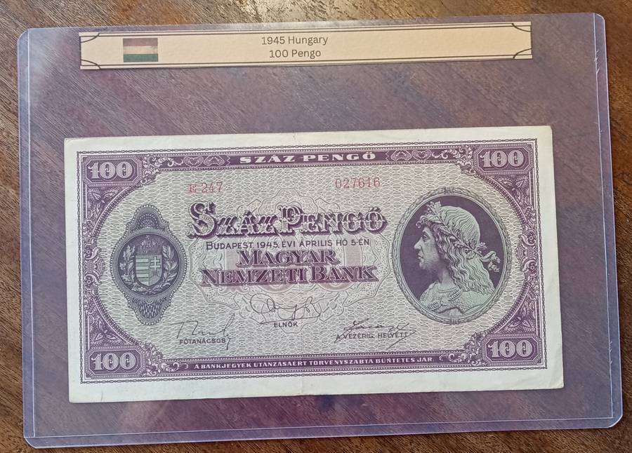1945 WW2 Hungary 100 Pengő note in hard plastic sleeve