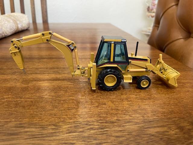 NZG - Caterpillar 428 Backhoe Loader with Hydraulic Hammer 1:50 scale