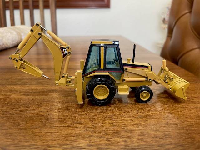 NZG - Caterpillar 428 Backhoe Loader with Hydraulic Hammer 1:50 scale