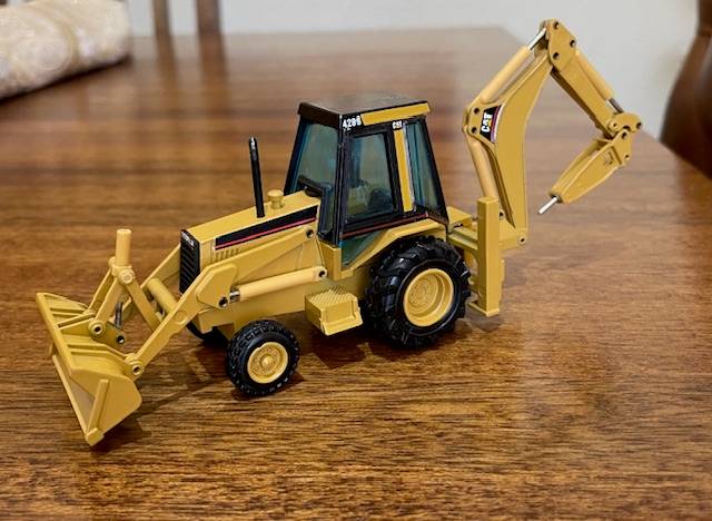 NZG - Caterpillar 428 Backhoe Loader with Hydraulic Hammer 1:50 scale