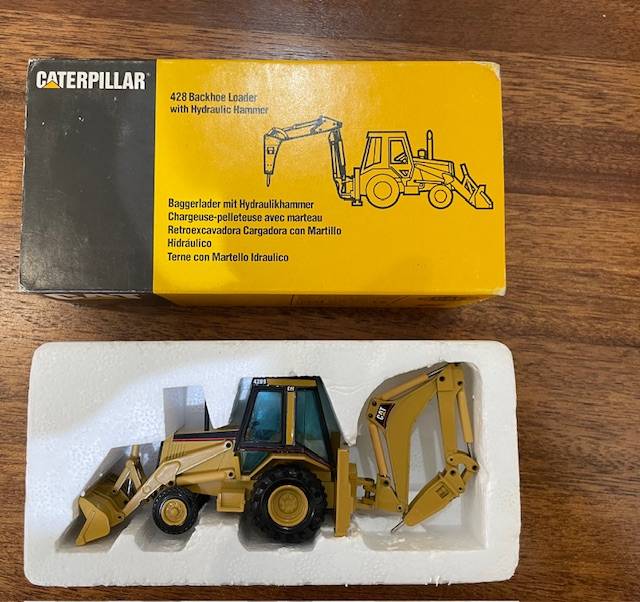 NZG - Caterpillar 428 Backhoe Loader with Hydraulic Hammer 1:50 scale