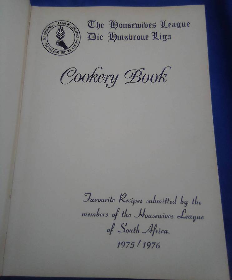 `"Die Huisvroue Liga / The Housewives League Cookery Book" Hard cover.