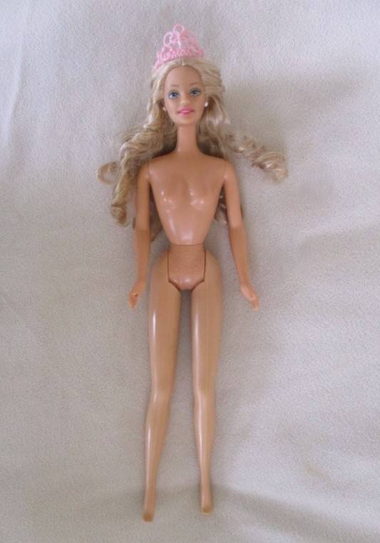 A Mattel Barbie with soft, curly hair with knees that bend - in pretty dress