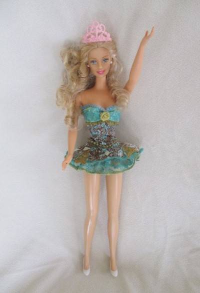 A Mattel Barbie with soft, curly hair with knees that bend - in pretty dress