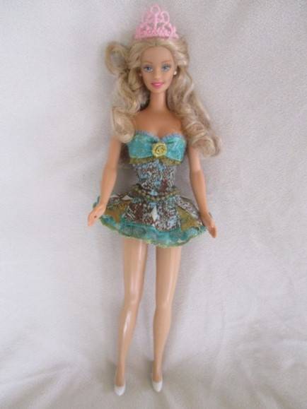 A Mattel Barbie with soft, curly hair with knees that bend - in pretty dress