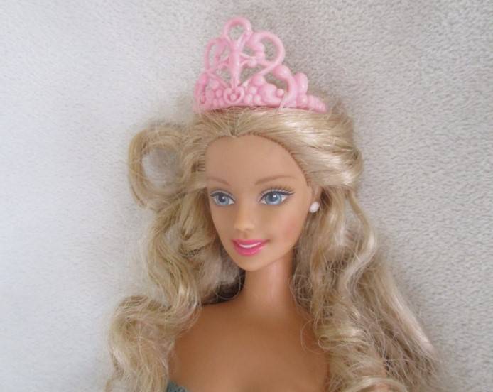 A Mattel Barbie with soft, curly hair with knees that bend - in pretty dress