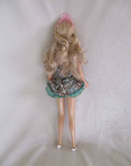 A Mattel Barbie with soft, curly hair with knees that bend - in pretty dress