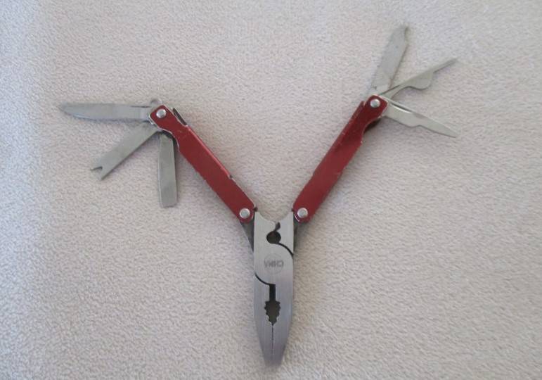 Small vintage Victorinox Swiss Army Knife plus other small fold-up tool gadget