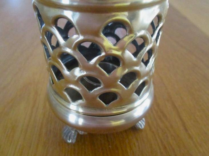 A lovely ornate footed brass lantern-style candle holder