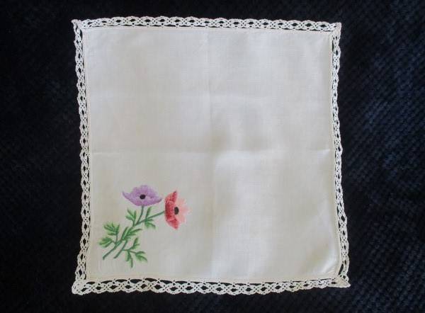 A vintage,  expertly embroidered square cloth with anemones and crocheted border