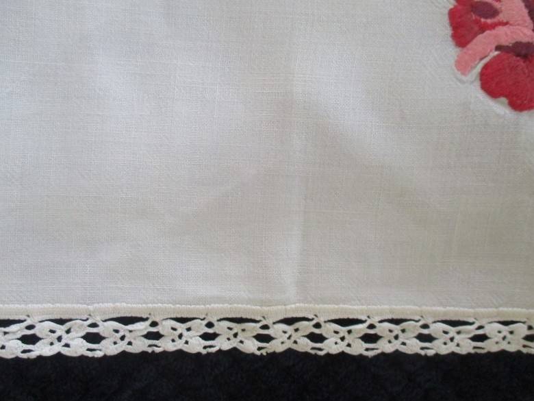 A vintage,  expertly embroidered square cloth with roses and crocheted border