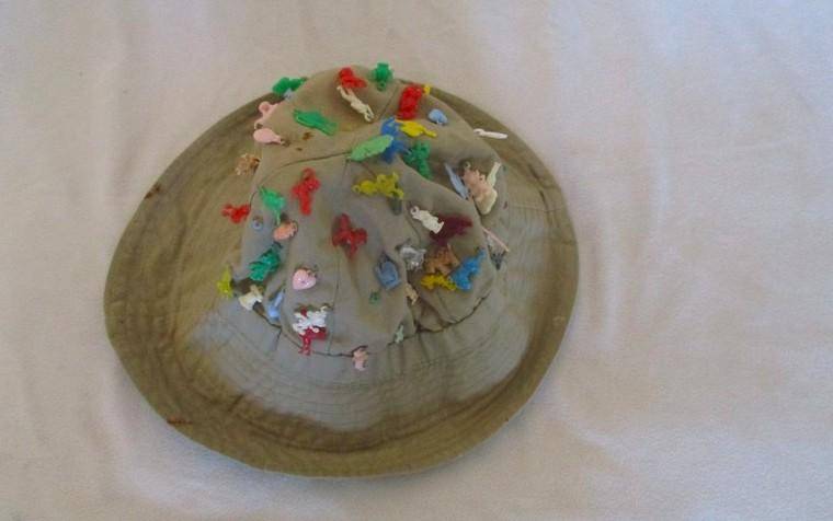 Vintage plastic charms - 62 of them on an old khaki hat!