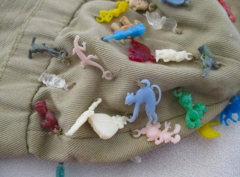 Vintage plastic charms - 62 of them on an old khaki hat!