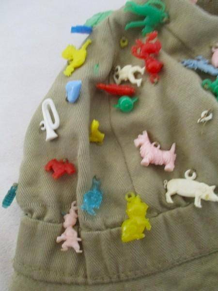 Vintage plastic charms - 62 of them on an old khaki hat!
