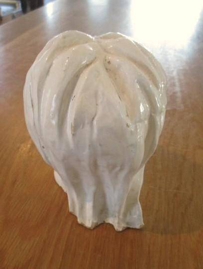 A vintage shabby chic glazed pottery head for inside or outside