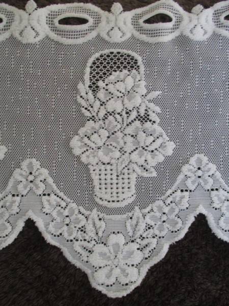 A special vintage `half mast` lace curtain with textured flowers in basket design