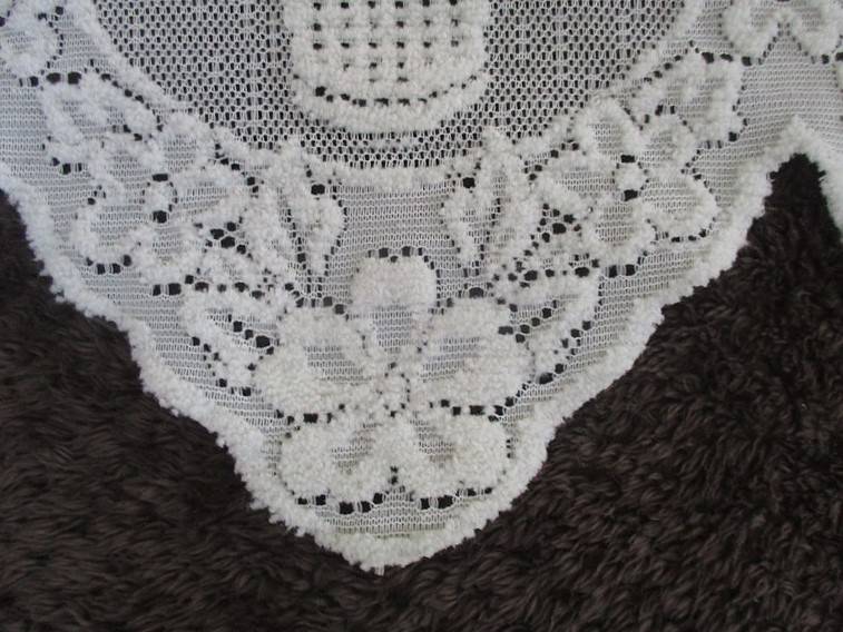 A special vintage `half mast` lace curtain with textured flowers in basket design
