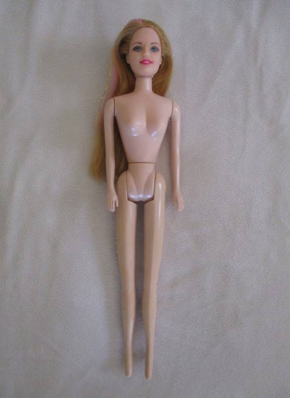 A pretty vintage doll with pink highlights and tinsel in her hair