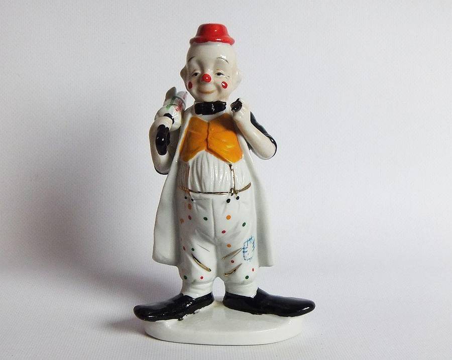 A vintage porcelain cigar smoking clown ornament