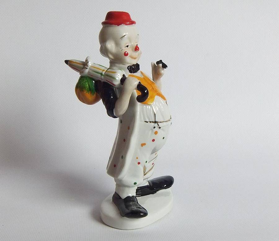 A vintage porcelain cigar smoking clown ornament