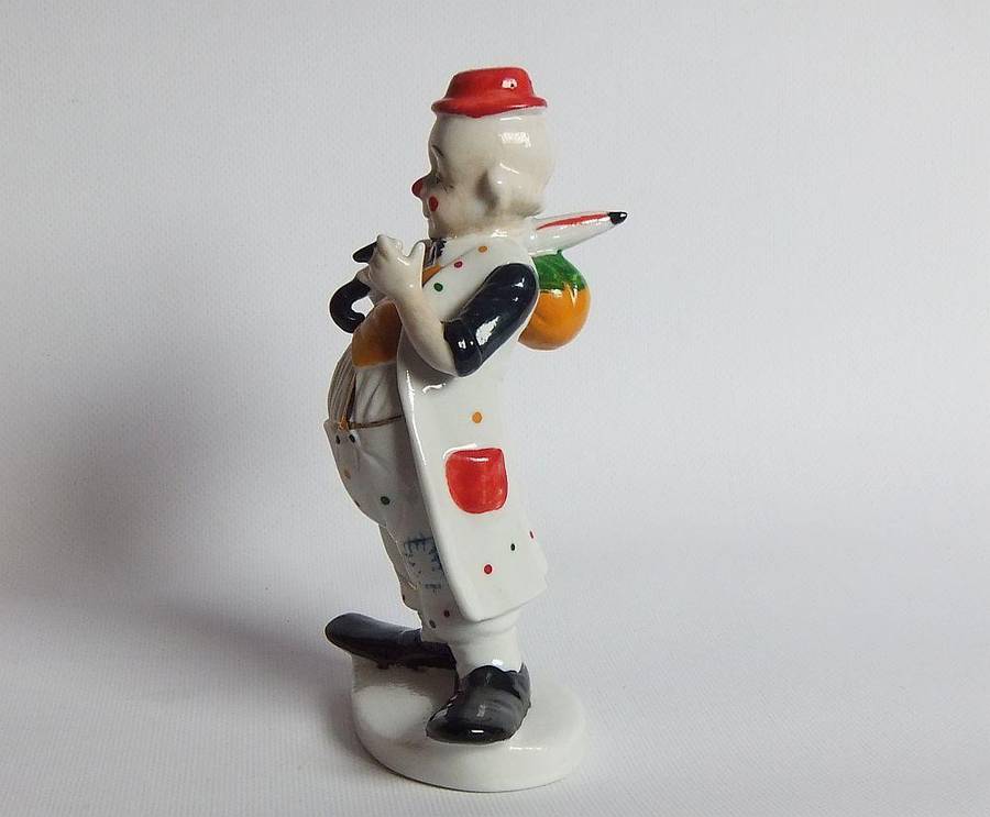 A vintage porcelain cigar smoking clown ornament