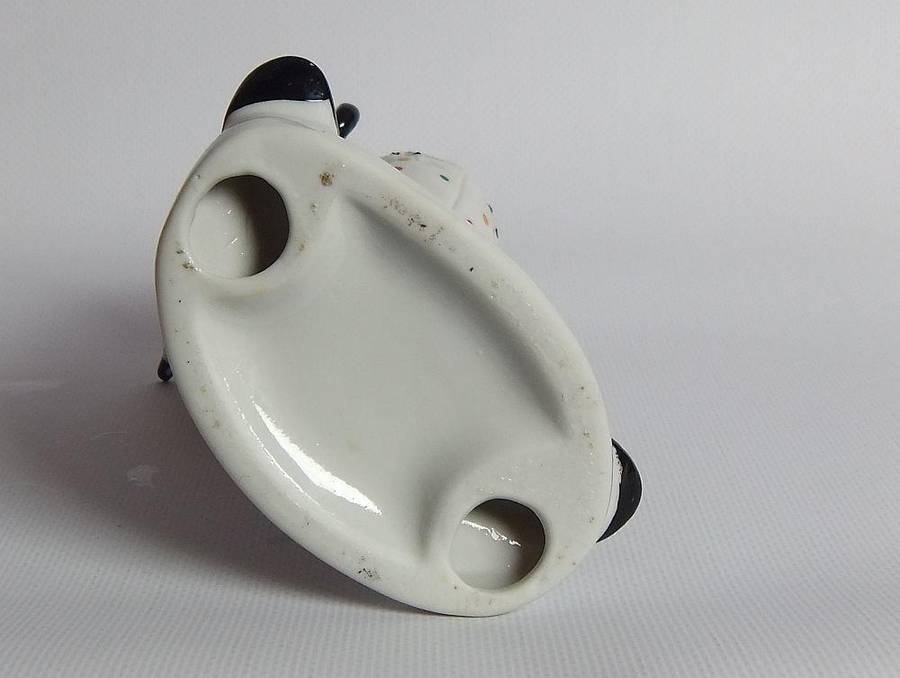 A vintage porcelain cigar smoking clown ornament