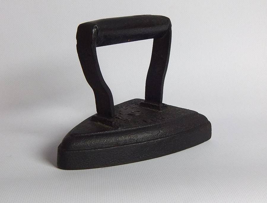 An antique coal stove iron or doorstop