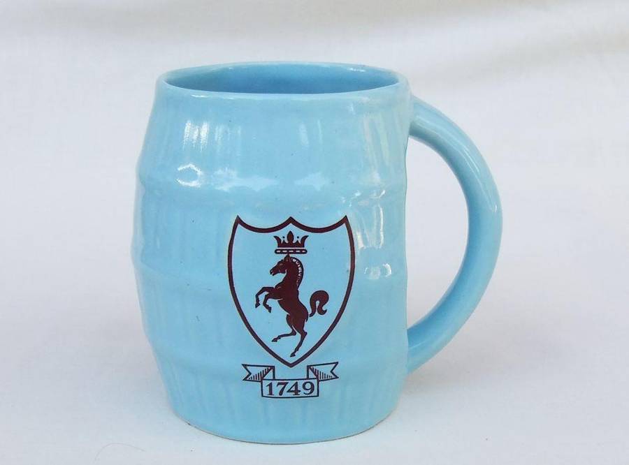 A vintage South African pottery mug with equestrian theme