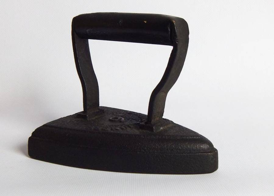 An antique coal stove iron or doorstop