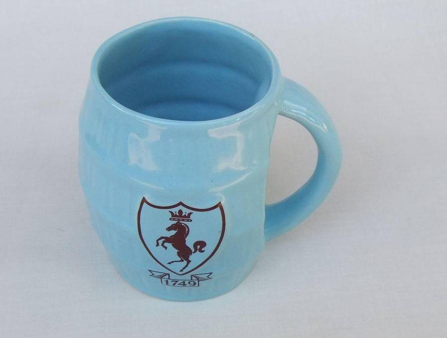 A vintage South African pottery mug with equestrian theme