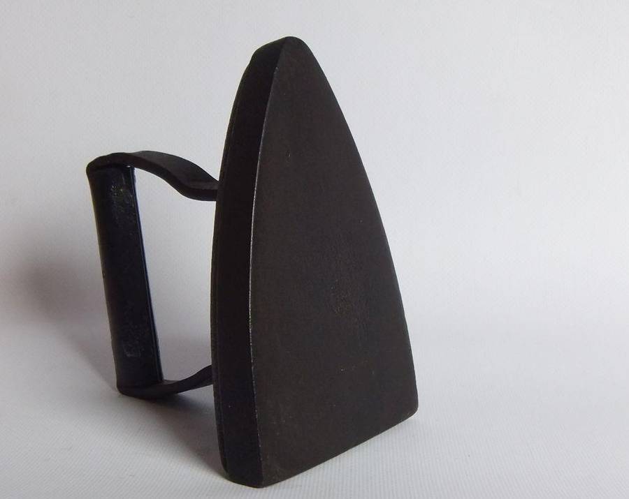 An antique coal stove iron or doorstop