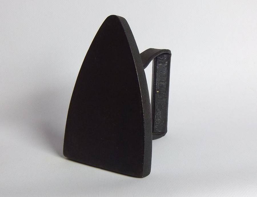 An antique coal stove iron or doorstop