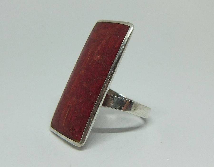 A unique adjustable sterling silver ring set with genuine coral
