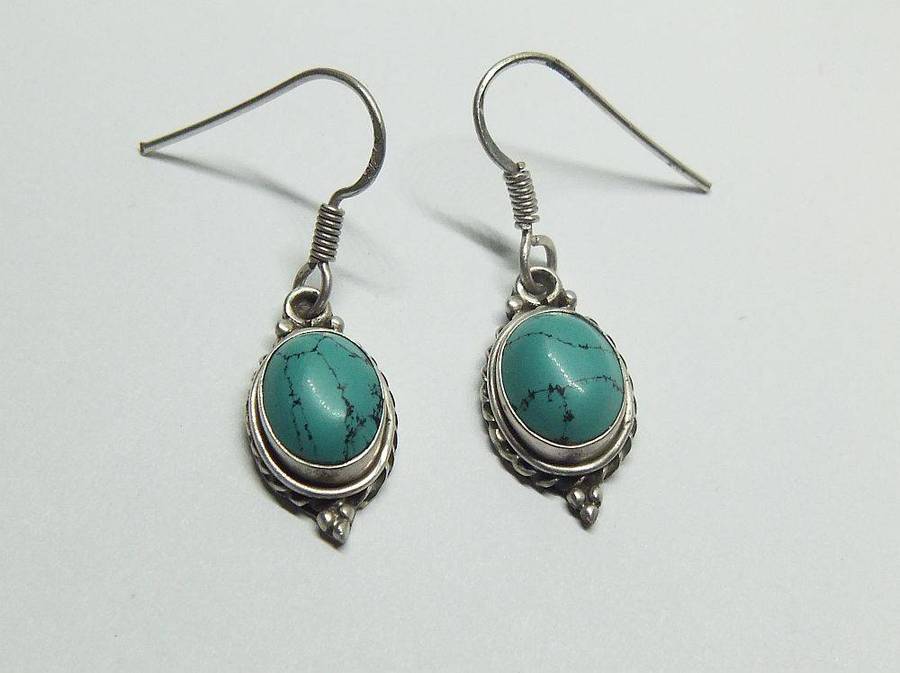 A pair of vintage sterling silver earrings set with cabochon Turquoise stones
