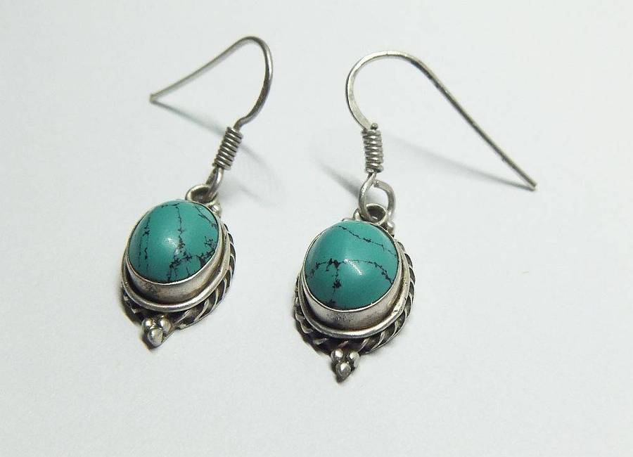 A pair of vintage sterling silver earrings set with cabochon Turquoise stones